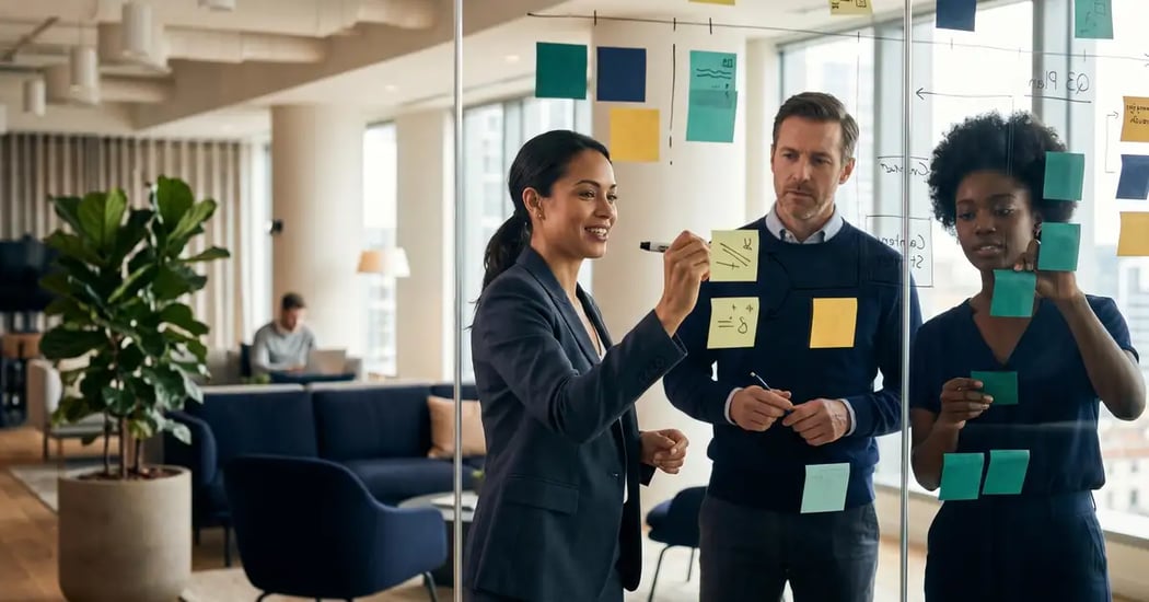 A B2B marketing team planning a 90-day AI search optimization roadmap on a glass wall