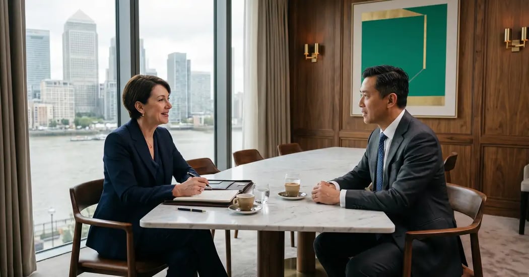 Senior executive search consultant conducting discovery conversation with C-suite executive candidate in sophisticated London private dining room