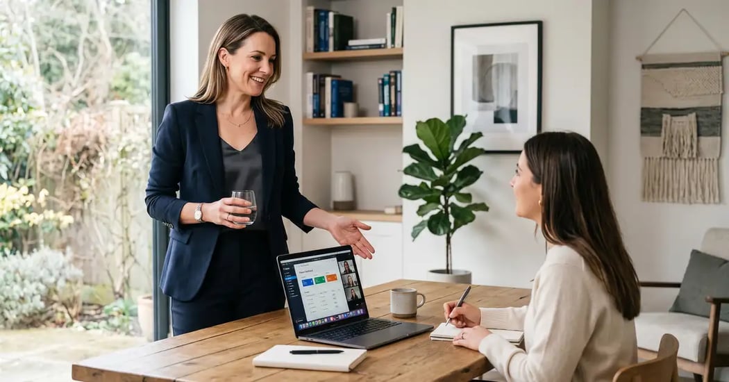 Boutique consultant stepping back from a laptop after delegating work, illustrating a virtual assistant strategy that reclaims founder time