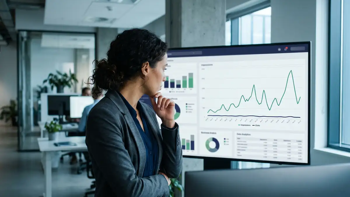 B2B marketing executive reviewing a dashboard showing high impressions but collapsing click-through rate in the AI era